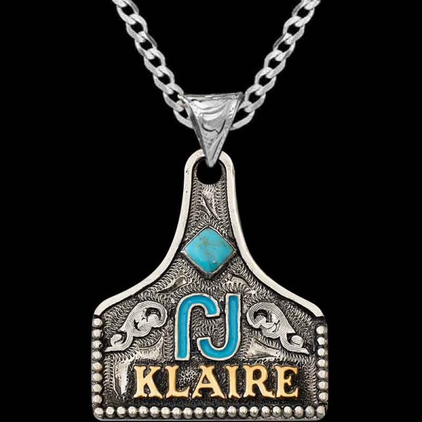 "Our Kali Custom Cow Tag Necklace crafted on a German Silver base with hand-engraved scrolls, it features a diamond simulated Turquoise stone, a hand-painted figure, and Jeweler's Bronze lettering, completed with our signature antique finish. Persona